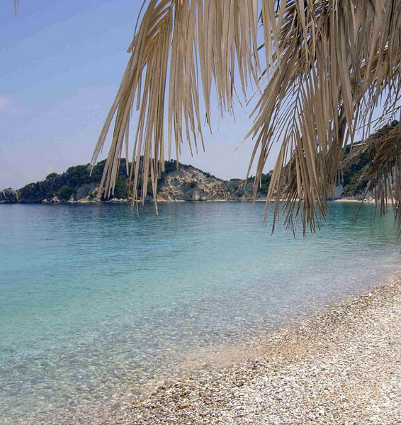 Emerald waters and white pebbles in an evergreen setting